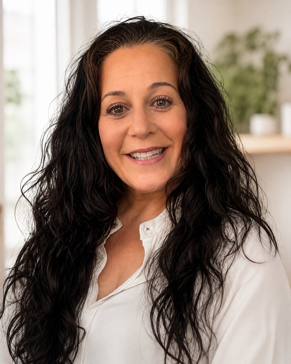 Angela, owner of Fresh Start Home Cleaning, smiling in a softly lit room.